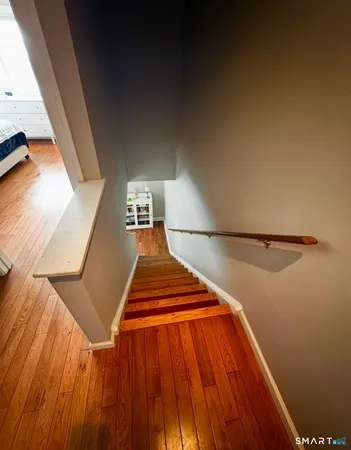 a view of a room with wooden floor