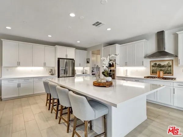 a kitchen with stainless steel appliances a stove a sink a stove a refrigerator and cabinets