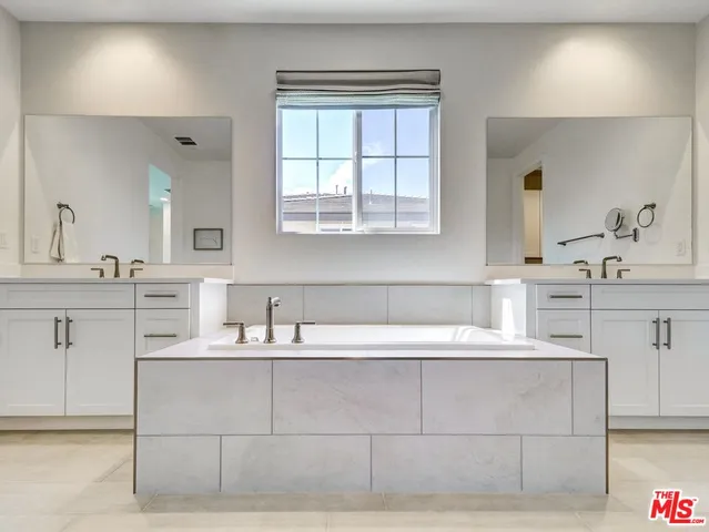 a bathroom with a bathtub sink and window