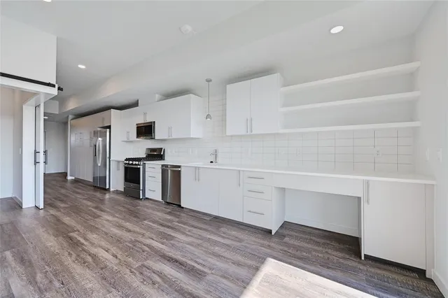 a kitchen with wooden floors a stove and a wooden floor