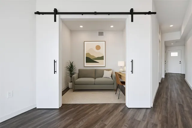 a view of room with wooden floor and fan