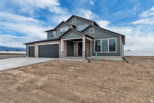 3317 South 1000 West, Unit 6010 Logan, UT 84321 - Photo 2 of 34 View of front of property featuring driveway, a porch, board and batten siding, and an attached garage