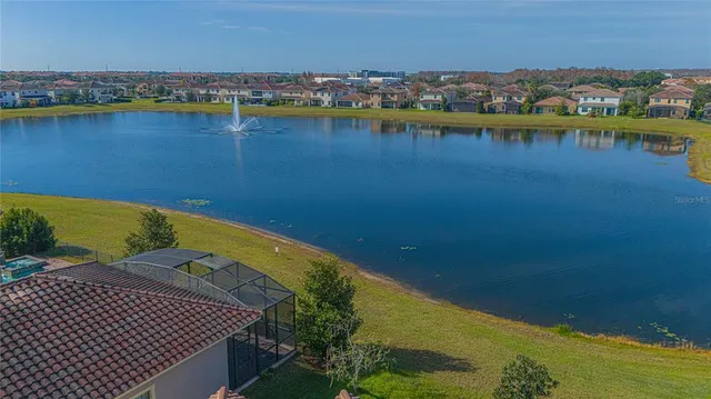 an aerial view of a houses with a lake view