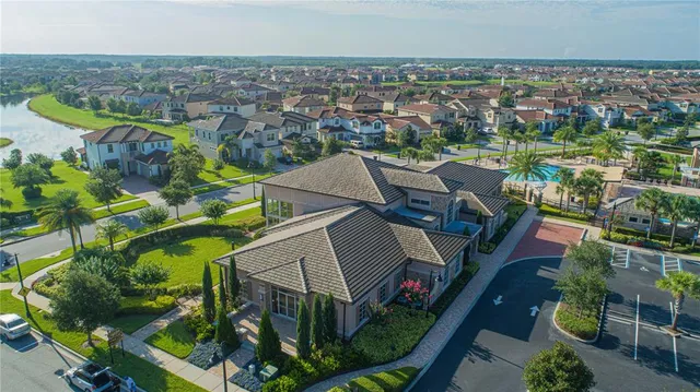 an aerial view of a house with swimming pool and outdoor seating