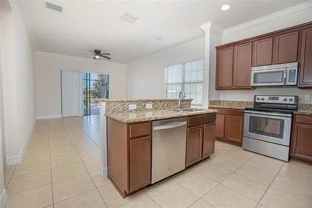 a kitchen with stainless steel appliances granite countertop a stove and a sink