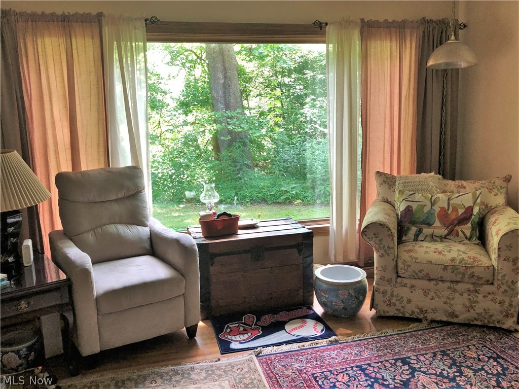 9674 Fairmount Road Novelty, OH 44072 - Photo 4 of 17 Living Room with fireplace andhardwood floors. Picture window with beautiful views of the wooded and private yard.
