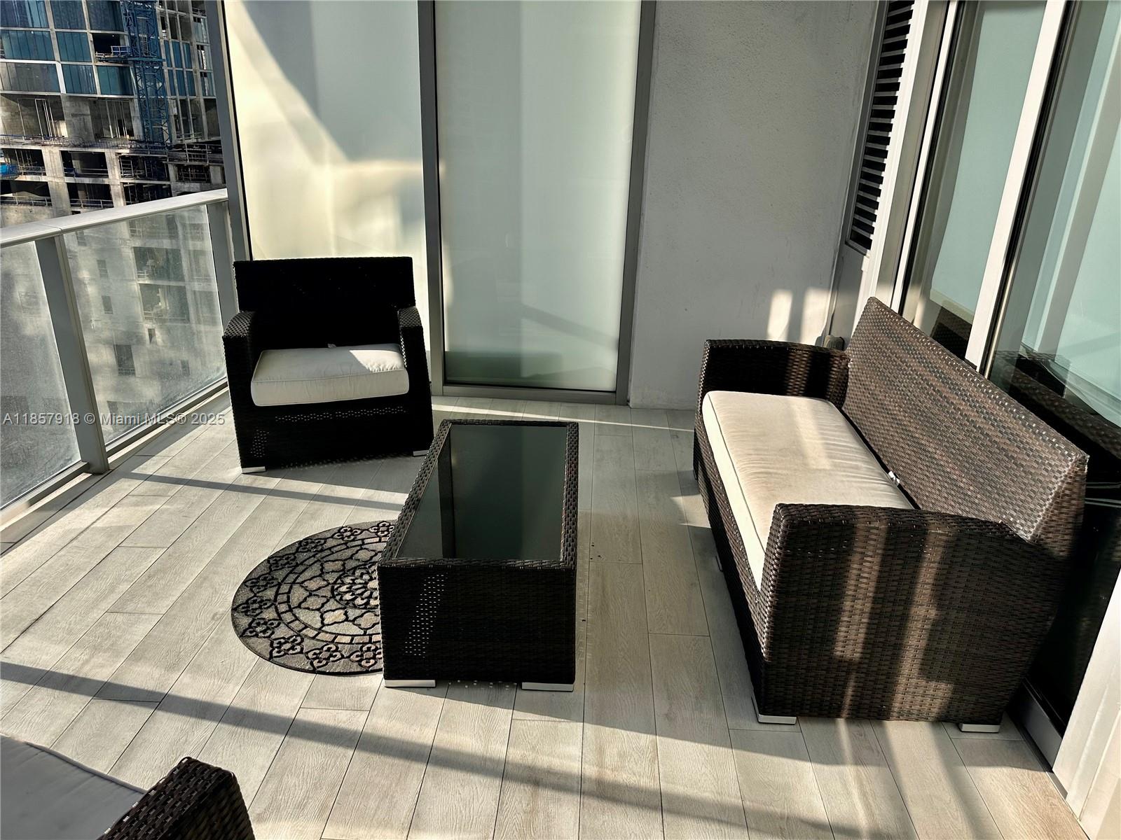 851 Northeast 1st Avenue, Unit 1106 Miami, FL 33132 - Photo 15 of 15 a living room with a rug and a fireplace