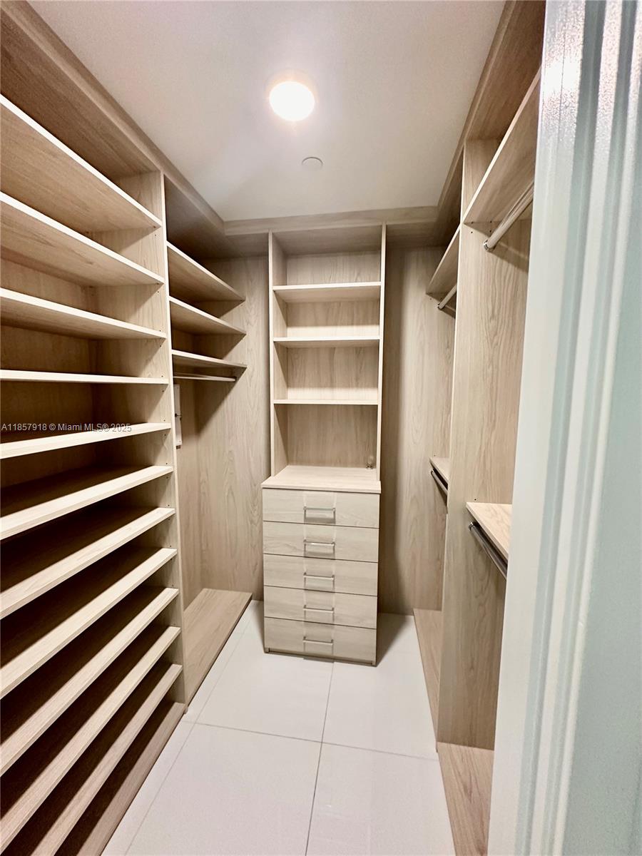 851 Northeast 1st Avenue, Unit 1106 Miami, FL 33132 - Photo 10 of 15 a view of walk in closet with empty racks