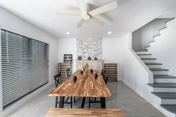 a dining room with furniture and wooden floor