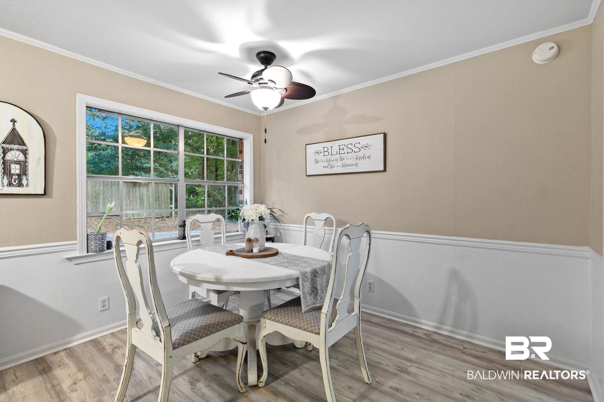4 Rally Road Spanish Fort, AL 36527 - Photo 16 of 41 Dining area with ornamental molding, light wood-style floors, ceiling fan, and a wainscoted wall