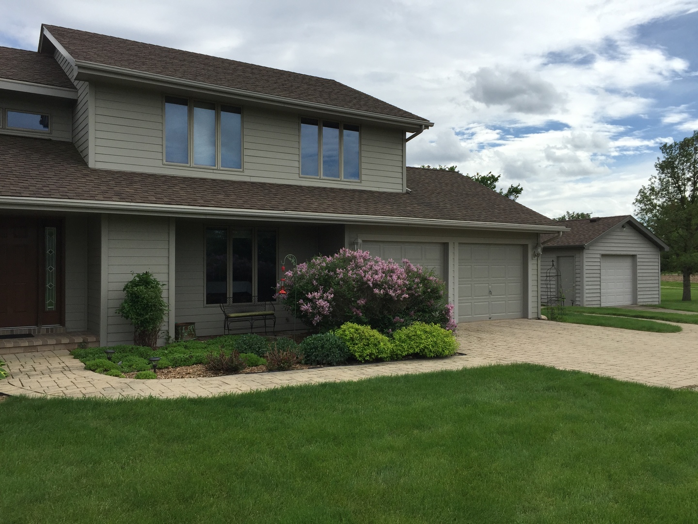 4900 Stockdale Road Morris, IL 60450 - Photo 1 of 33 a front view of a house with a garden and plants
