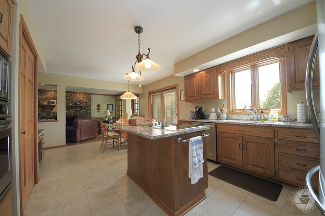 4900 Stockdale Road Morris, IL 60450 - Photo 12 of 33 a view of a kitchen with kitchen island granite countertop a sink and a stove top oven