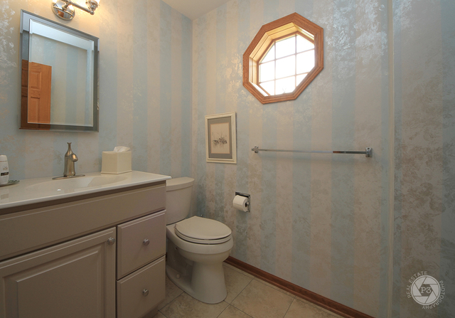 4900 Stockdale Road Morris, IL 60450 - Photo 16 of 33 a bathroom with a toilet sink vanity and mirror
