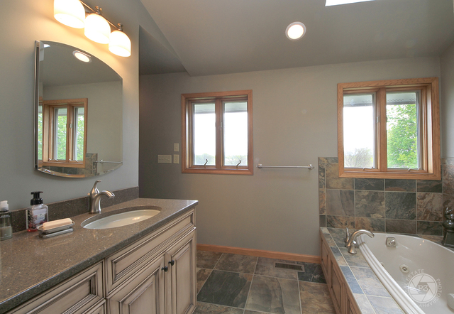 4900 Stockdale Road Morris, IL 60450 - Photo 21 of 33 a bathroom with a granite countertop sink and a bathtub
