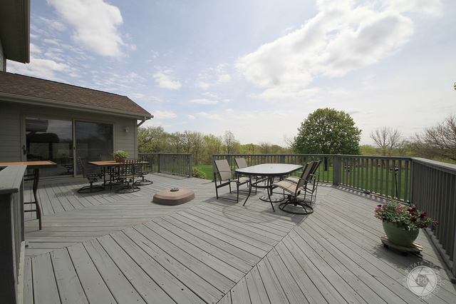 4900 Stockdale Road Morris, IL 60450 - Photo 28 of 33 a view of a roof deck with table and chairs a barbeque with wooden floor and fence