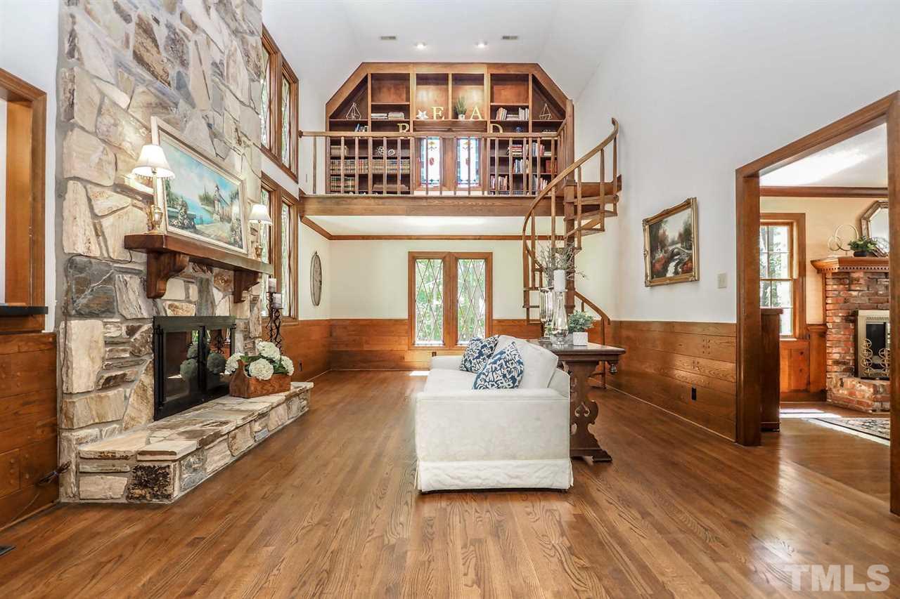 5009 Field And Stream Road Raleigh, NC 27613 - Photo 3 of 12 LIVING room with a unique SPIRAL staircase leading to a reading NOOK.