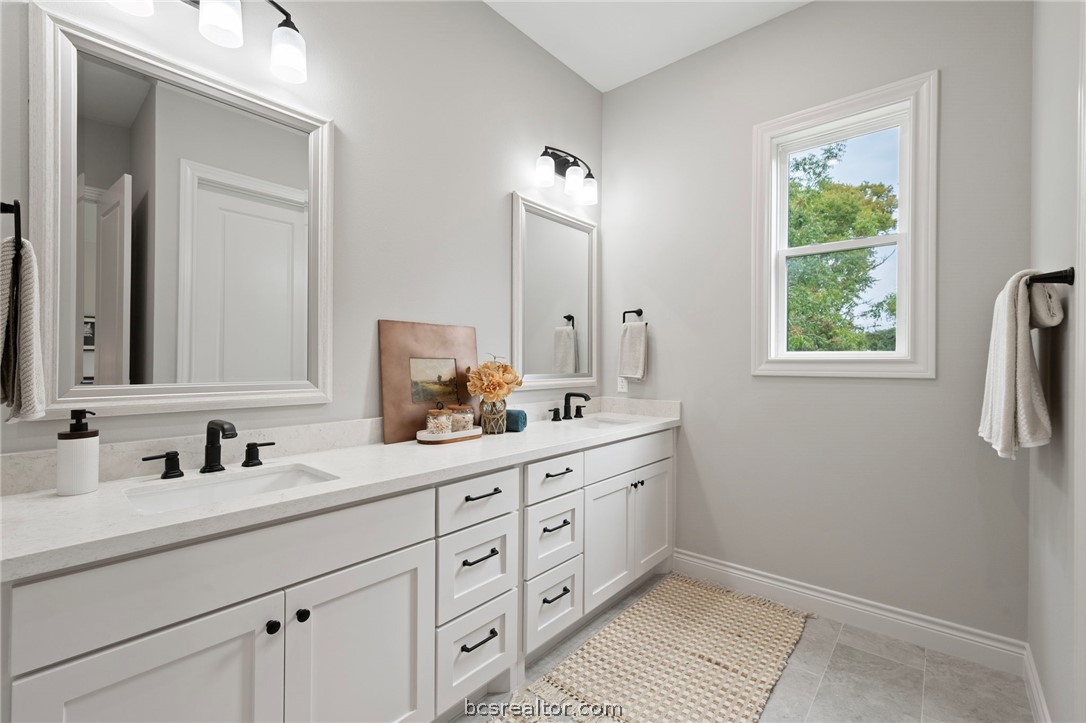 13291 Hopes Creek Road College Station, TX 77845 - Photo 15 of 45 Full bathroom with double vanity and light tile patterned floors