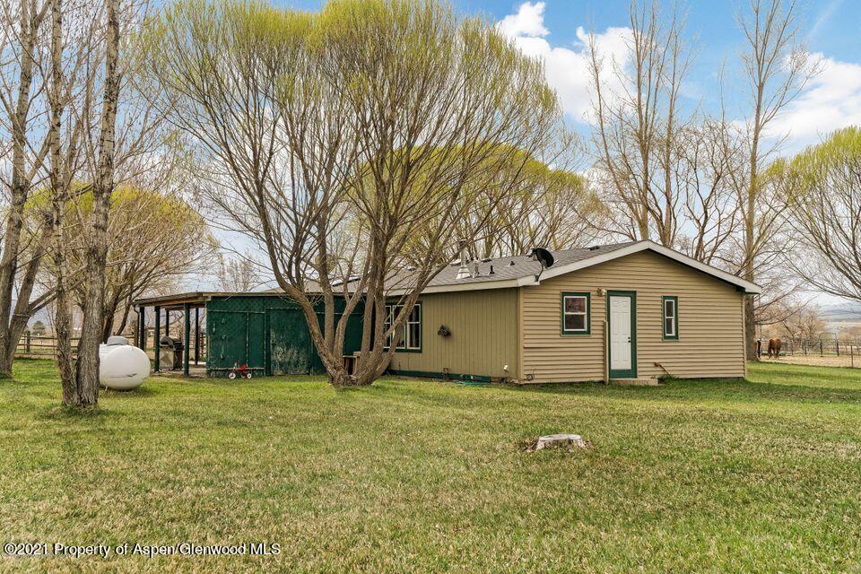 1969 County Road 210 Rifle, CO 81650 - Photo 1 of 1 a house that has a tree in front of it