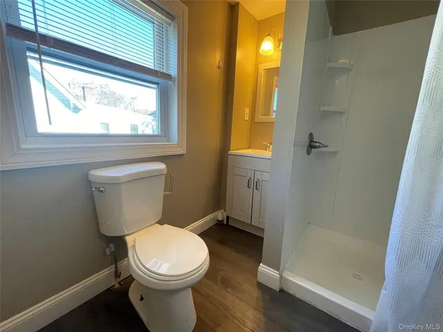 a white toilet sitting next to a bathroom sink and tub