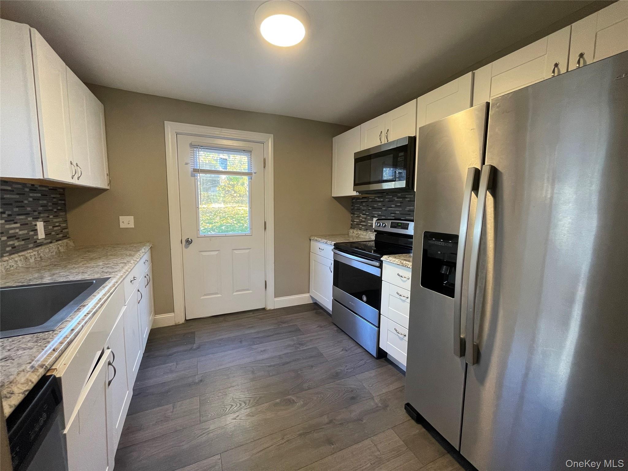 101 Delafield Street Poughkeepsie, NY 12601 - Photo 2 of 16 a kitchen with stainless steel appliances granite countertop a refrigerator stove and sink