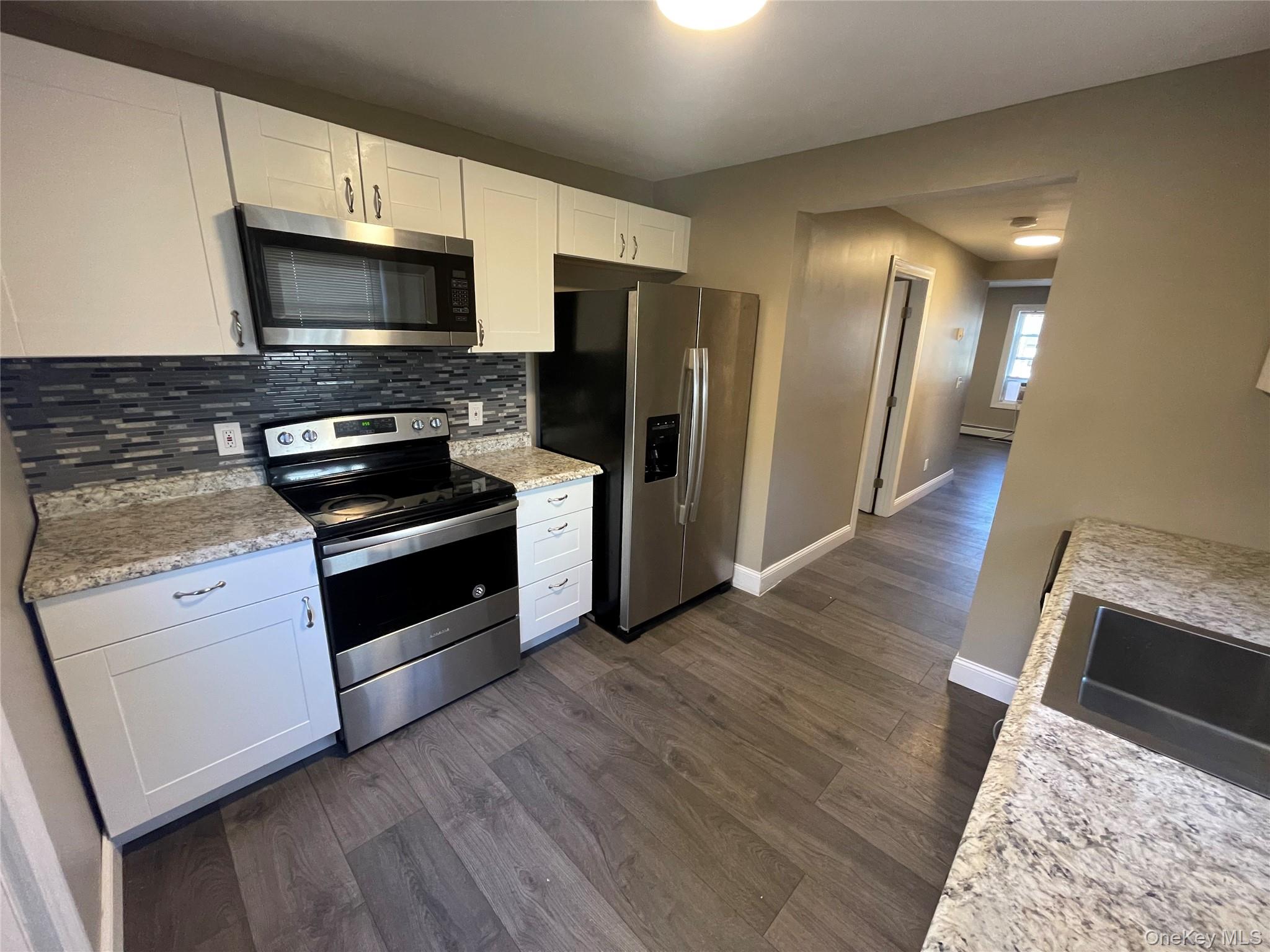 101 Delafield Street Poughkeepsie, NY 12601 - Photo 3 of 16 a kitchen with granite countertop wooden cabinets and stainless steel appliances