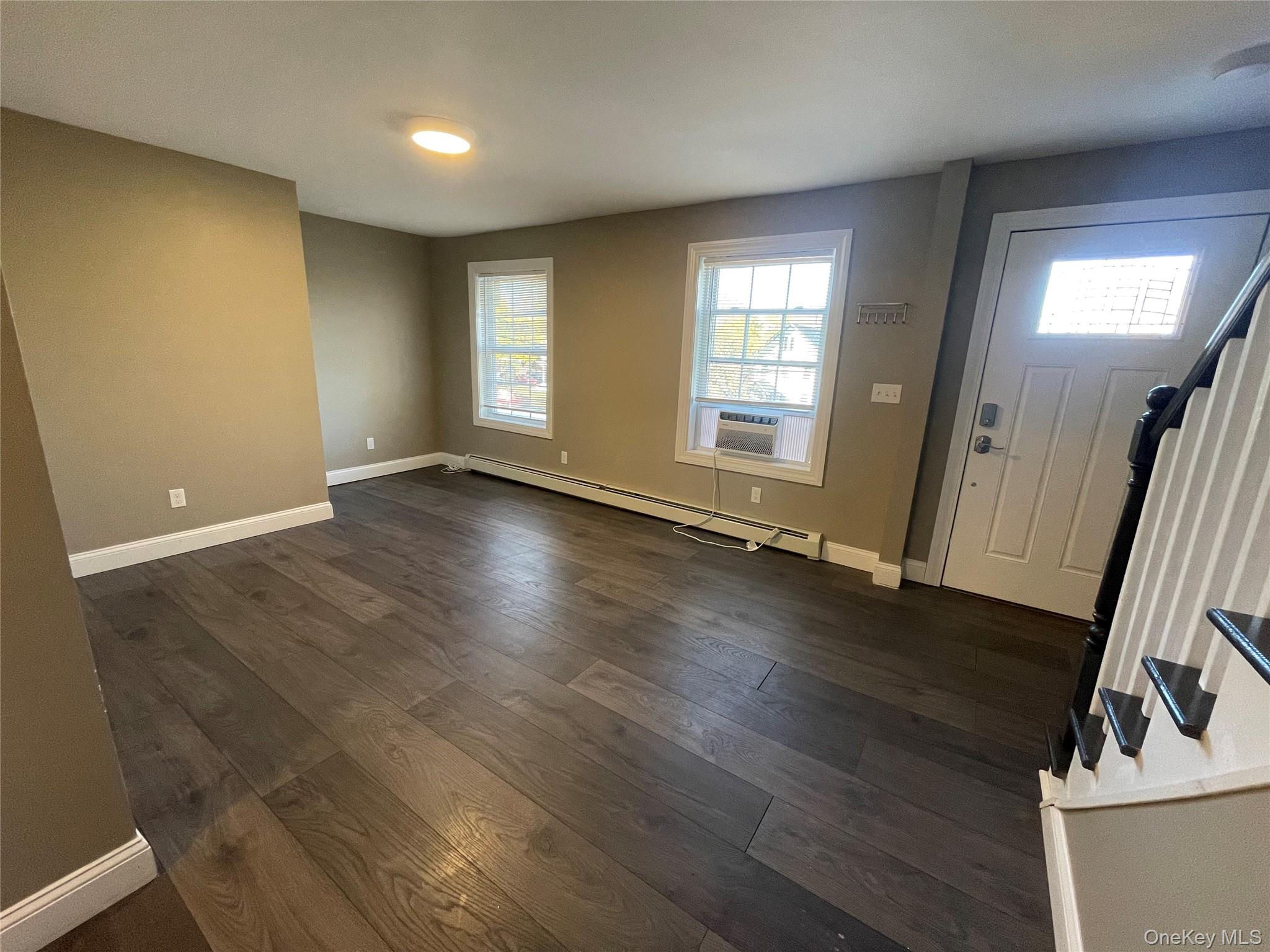 101 Delafield Street Poughkeepsie, NY 12601 - Photo 5 of 16 an empty room with wooden floor and windows