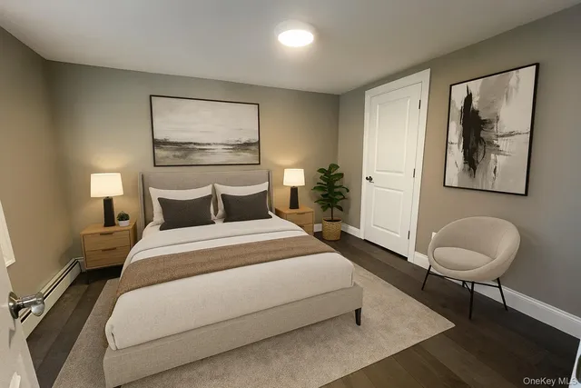 a bedroom with a bed and painting on the wall