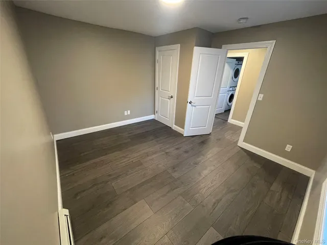 an empty room with wooden floor and closet