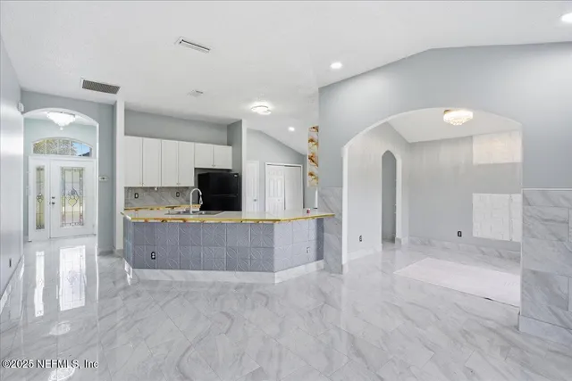 a large kitchen with cabinets and stainless steel appliances