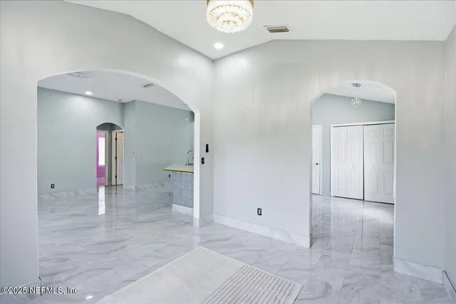 a kitchen with granite countertop a refrigerator stove top oven and sink