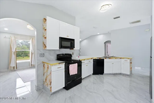 a kitchen that has a sink and a stove