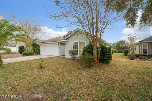 a yellow house with trees in front of it
