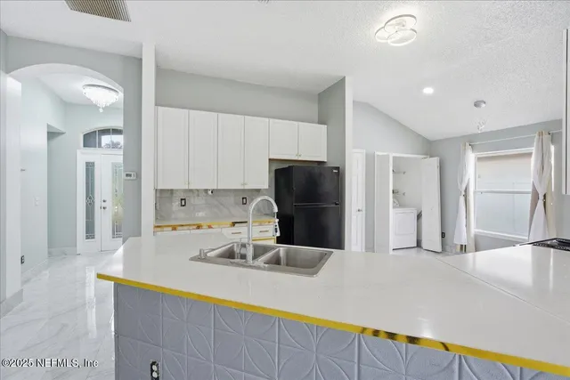 a large kitchen with stainless steel appliances kitchen island a large counter top and a stove