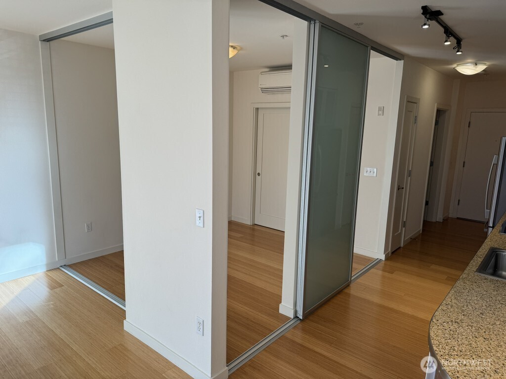3104 Western Avenue, Unit 215 Seattle, WA 98121 - Photo 10 of 18 a view of a hallway with wooden floor