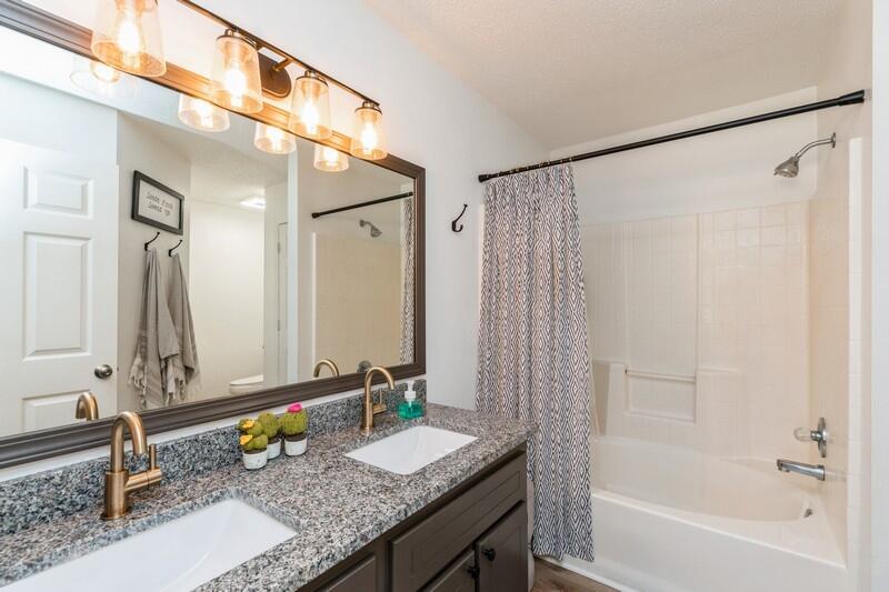 2763 Augustus Road Navarre, FL 32566 - Photo 25 of 31 a bathroom with a granite countertop sink and a mirror
