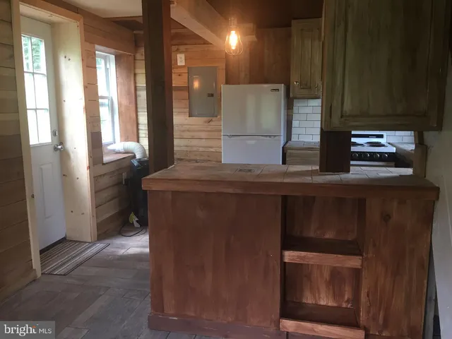 a kitchen with stainless steel appliances granite countertop a refrigerator and a stove