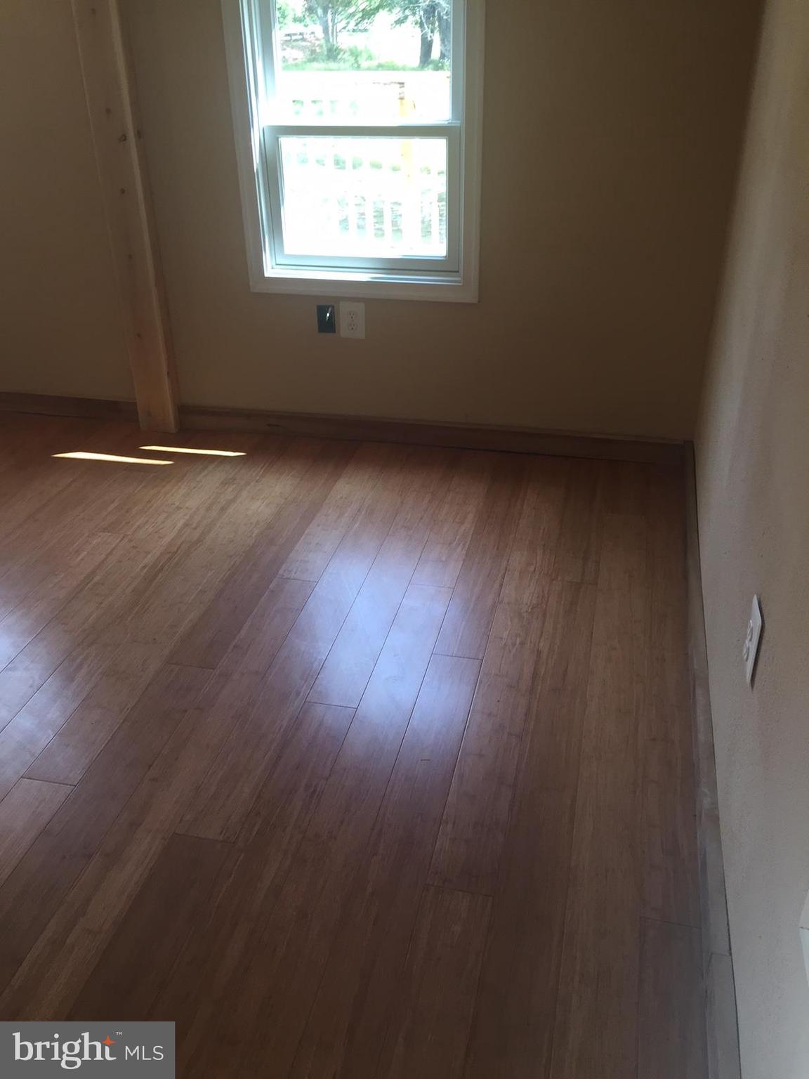 4609 B Dumfries Road Catlett, VA 20119 - Photo 10 of 16 an empty room with wooden floor and windows