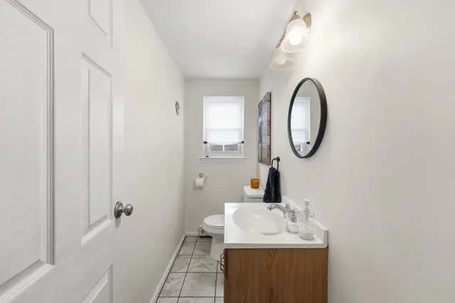 a bedroom with a bed and a flat tv screen on dresser