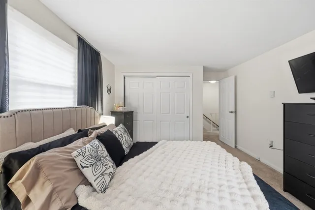 a bedroom with a bed and flat screen tv
