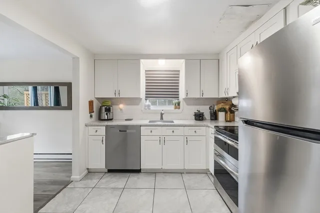 a kitchen with a refrigerator and a sink
