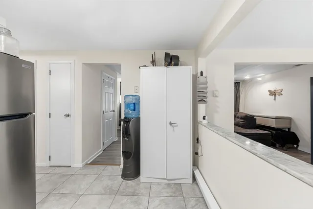 a living room with furniture a chandelier and a window
