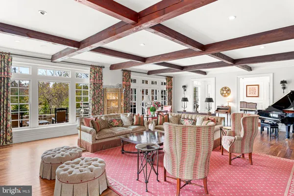 a view of a dining room with furniture a chandelier and wooden floor