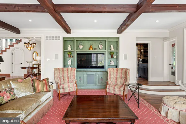 a living room with furniture and a chandelier