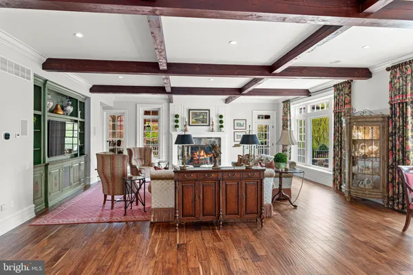 a dining room with furniture a chandelier and wooden floor