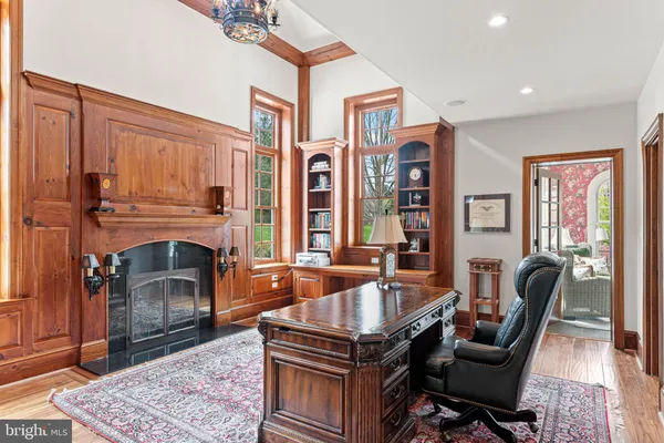 a view of a dining room with furniture a chandelier and wooden floor