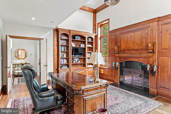 a view of a room with wooden floor and windows
