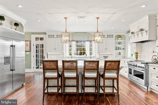 a kitchen with granite countertop a sink and a refrigerator