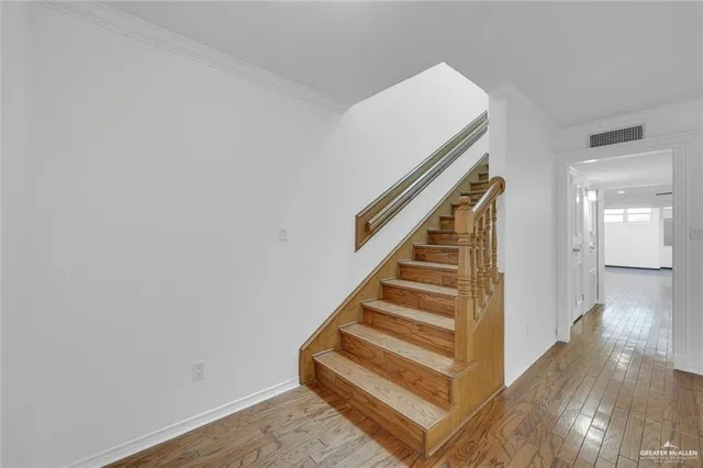 a view of entryway and hall with wooden floor