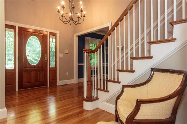205 Marrett Road Lexington, MA 02421 - Photo 3 of 16 a view of a hallway with wooden floor and staircase