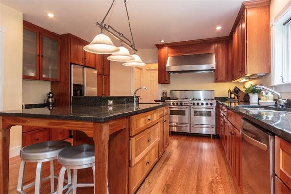 205 Marrett Road Lexington, MA 02421 - Photo 6 of 16 a kitchen with stainless steel appliances granite countertop a stove a sink and a refrigerator